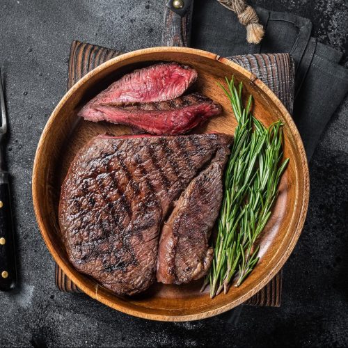 bbq-grilled-medium-rare-top-sirloin-beef-steak-rump-steak-in-a-wooden-plate-e1664111691605.jpg